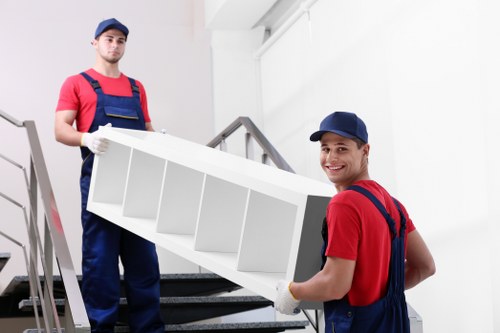 Removal team loading boxes and household items in central London
